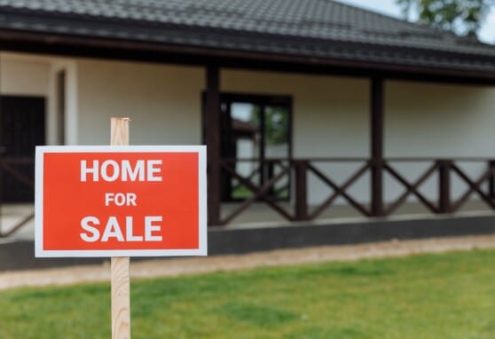 Red sign that says home for sale