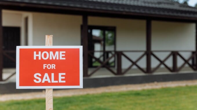 Red sign that says home for sale