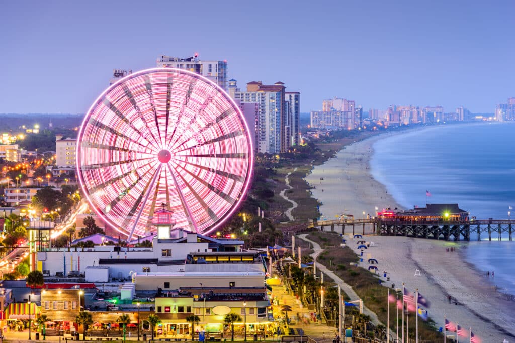 View of Myrtle Beach boardwalk ferris wheel at dusk. 